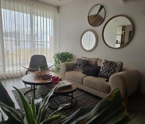 a living room with a couch and a table at Luxury Oceanfront Apartment Spiaggia 2BR 3BA Playa azul Cartagena in Cartagena de Indias