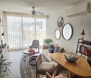 a living room with a couch and a table at Luxury Oceanfront Apartment Spiaggia 2BR 3BA Playa azul Cartagena in Cartagena de Indias
