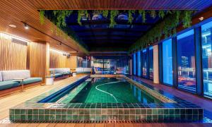 a swimming pool in the middle of a building at Rockefeller Foreshore Studio Fast WiFi, Gym & Pool in Cape Town
