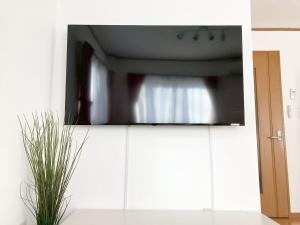 a tv sitting on top of a white cabinet at Neo Universal 05 in Wada +66 photos