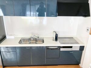 a small kitchen with a sink and a stove at Neo Universal 05 in Wada