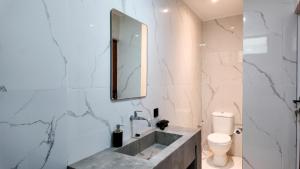 a bathroom with a sink and a toilet at Pulau Indah Lombok in Kuta Lombok +15 photos