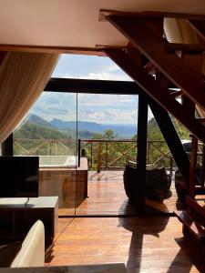 a room with a balcony with a view of the mountains at Nature Senses Chapadinha in Cavalcante