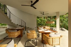 a patio with tables and chairs and a staircase at The Sevana in Talalla South
