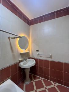 a bathroom with a toilet and a sink and a mirror at Dahabiya Apartment in Luxor +47 photos