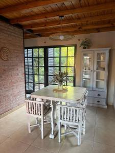 a dining room with a table and two chairs at Loft del centro Saladillo in Saladillo +11 photos