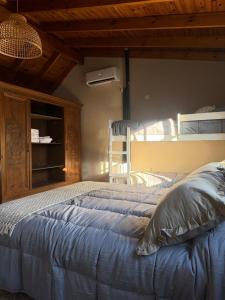 a bedroom with a bed and a bunk bed at Loft del centro Saladillo in Saladillo