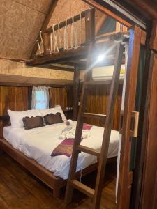 a bunk bed in a room with a ladder at Baancherda in Ban Nong Hu