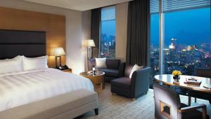 a hotel room with a bed and a desk and chair at BREEV GWANGJU by LOTTE HOTELS, formerly Ramada Plaza by Wyndham Gwangju in Gwangju
