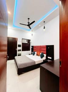 a bedroom with a bed and a blue ceiling at The Miraj Hotel in Murthal