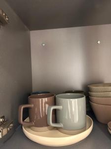 two coffee mugs sitting on a plate in a kitchen at 케이 코지 하우스 - 스튜디오 in Seoul +8 photos