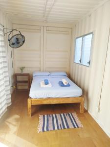 a bedroom with a bed with two towels on it at Hotel Marea in San Juan del Sur