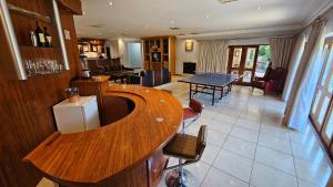a kitchen and living room with a table and chairs at Grobler's Haven On Vaal - Barrage in Tumahole