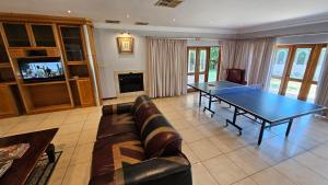 a living room with a ping pong table at Grobler's Haven On Vaal - Barrage in Tumahole