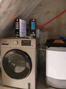 a washing machine with two speakers on top of it at RD's Apartment in Eyeb, Poblacion, Bontoc in Bontoc