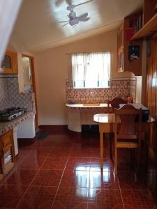 a kitchen with a table and chairs and a window at RD's Apartment in Eyeb, Poblacion, Bontoc in Bontoc