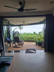 a living room with a couch and a ceiling fan at The Aspasia Kata Beach in Kata Beach +4 photos