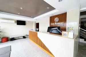 an office lobby with a reception desk and a sign that reads la rover at Lea Robert Hotel Angeles City in Angeles