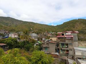 a city with houses and a mountain in the background at RD's Apartment in Eyeb, Poblacion, Bontoc in Bontoc