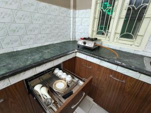 a kitchen counter with a drawer with a radio on it at Prashaanti in Guwahati +47 photos