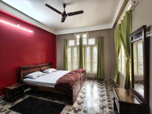 a bedroom with a bed and a ceiling fan at Prashaanti in Guwahati