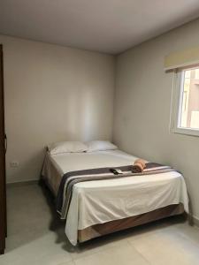 a bedroom with a bed with a tray on it at Elephant Lounge in Santa Cruz de la Sierra