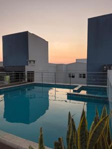 a large swimming pool in front of a building at Elephant Lounge in Santa Cruz de la Sierra