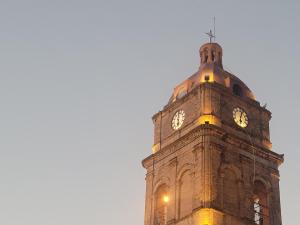 a tall clock tower with a clock on it at Elephant Lounge in Santa Cruz de la Sierra