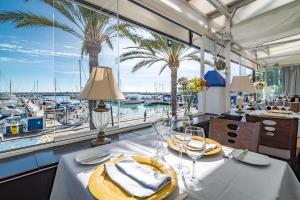 a dining room with a view of a marina at CP - Modern Beachside Apartment in Estepona in Estepona
