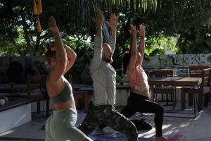a group of people doing yoga in a park at Mantra Homestay in Bacalar