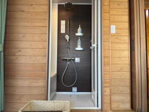 a shower stall in a bathroom with a shower at Hiogiso in Shima