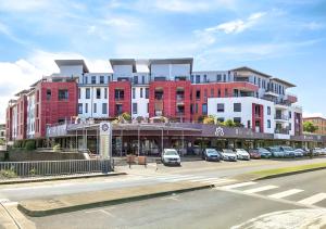 a large building with cars parked in a parking lot at Ambre du lagon in Saint-Pierre