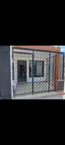 a metal fence with two windows in a building at Alquileres BH in La Rioja