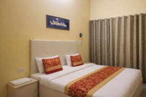 a bedroom with a large bed with two pillows at Royal Inn in Lucknow