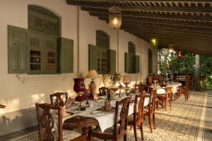 a restaurant with tables and chairs in a room at Ridee Kandy in Kandy
