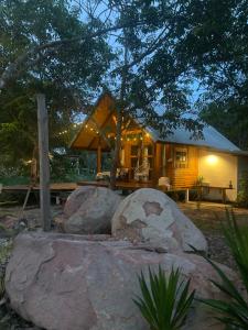 a small cabin with rocks in front of it at Baanraipoonwana Baanwanason in Ban Nong Hu