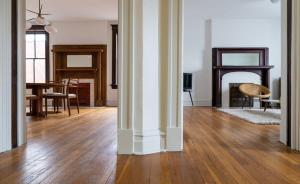 a living room with a table and a fireplace at Swanky Shaw 2BR with Office ABODEbucks in Tower Grove