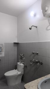 a bathroom with a toilet and a sink at Royal Inn in Lucknow
