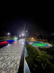 a night view of a swimming pool at a resort at Helens Mountain Resort in Binungan +37 photos