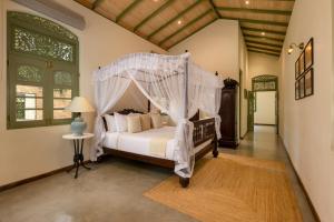 a bedroom with a bed with a canopy at Ridee Kandy in Kandy +36 photos