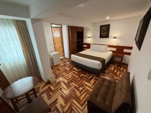 a hotel room with a bed and a couch at Awki´s Dream Hotel in Cusco