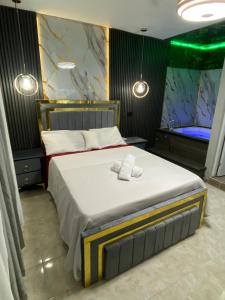 a bedroom with a large bed with two towels on it at Luxury and beautiful studio private jacuzzi in Santo Domingo