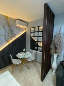 a dining room with a table and chairs and a window at Luxury and beautiful studio private jacuzzi in Santo Domingo