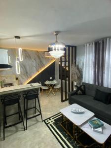 a living room with a couch and a table at Luxury and beautiful studio private jacuzzi in Santo Domingo