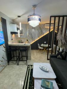 a living room and kitchen with a couch and a table at Luxury and beautiful studio private jacuzzi in Santo Domingo +5 photos