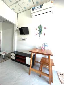 a living room with a table and a tv at Yada homestay in Ban Bu Lu
