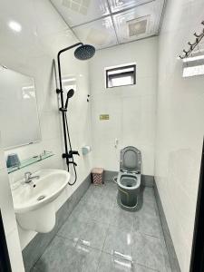 a bathroom with a toilet and a sink at THUẬN VƯƠNG Homestay in Vĩnh Hy