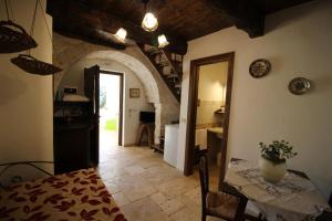 a kitchen and a dining room with a table and a hallway at Il Gabellota Resort in Alberobello