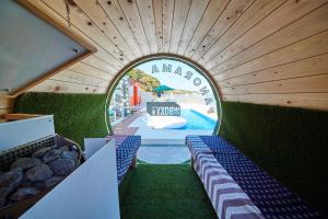 a view of a swimming pool through a circular window at THE BOXY AWAJI in Awaji