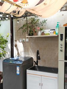 a kitchen with a sink and a refrigerator at In Spring Country Courtyard in Lijiang in Lijiang +27 photos